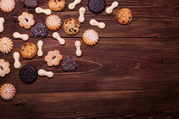 Various cookies on the wooden table