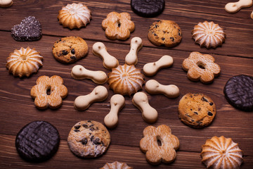Various cookies on the wooden table
