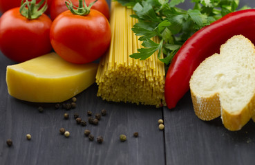 talian vegetables and spices on dark wooden background