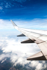 Obraz premium Cloudscape. Blue sky and white cloud. Sunny day. Wing of aircraft.