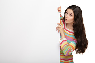 Happy smiling young woman showing blank signboard.