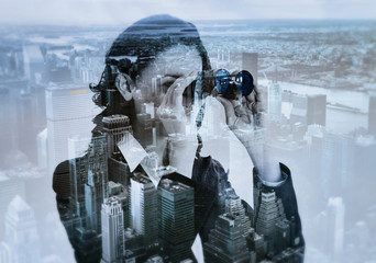 double exposure of businesswoman with binocular and megalopolis