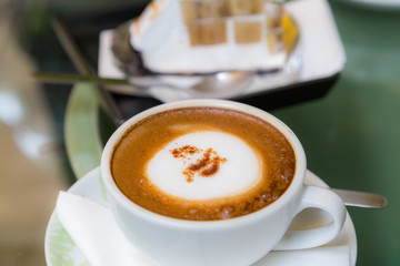 Hot cappuccino coffee cup and banana cake