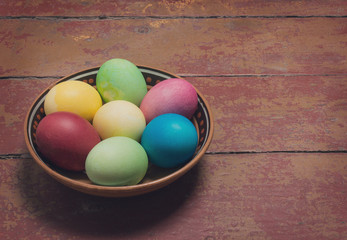 Multi-colored Easter eggs in a bowl. Retro