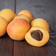 Naklejka na ściany i meble some fresh apricots on brown table