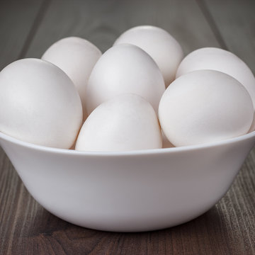eggs in white bowl on wooden table