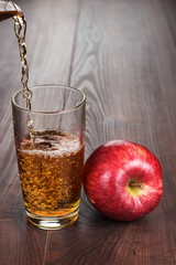 fresh apple juice pouring into glass