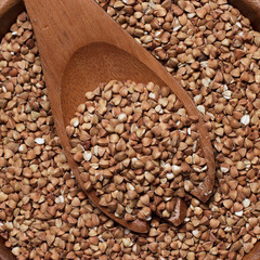 brown wooden bowl full of buckwheat