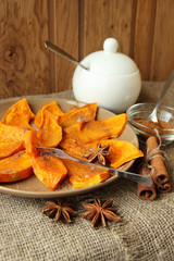 Plate with baked pumpkin, sprinkled with cinnamon