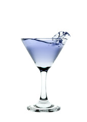 Blue liquid splashing in a martini glass isolated on white backg