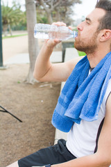 Fototapeta na wymiar man drinking water after exercise practice