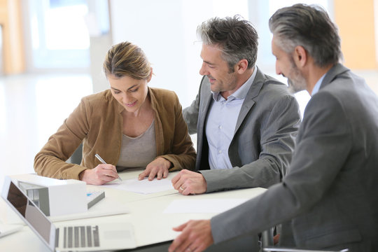 Mature couple signing contract 