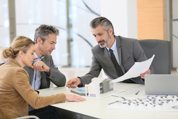 Mature couple meeting architect for construction project