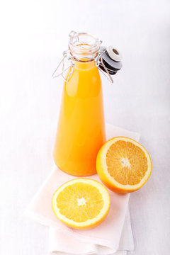 orange and a bottle of orange juice, white background