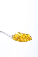 spoon of vitamin capsules