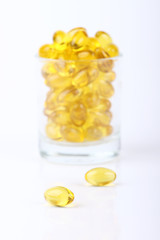 vitamin capsules  poured out of glass