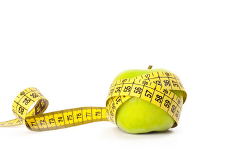 Green apple with measuring tape