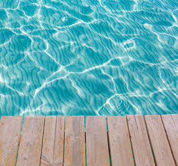 Tropical sea water texture from a wooden pier
