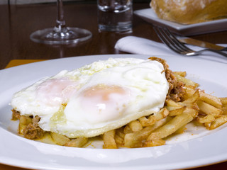 Dish of fried eggs on a potato chip