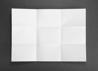 White sheet of paper folded in nine top shooting.