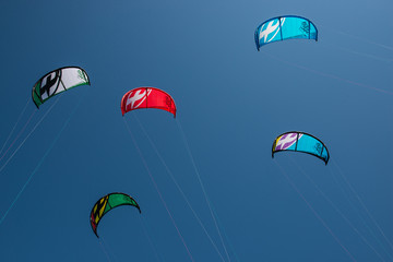 5 kites on a blue sky