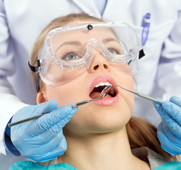 Tooth decay. Dental implants. Young woman visiting dentist