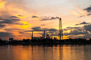 petrochemical plant in night time with reflection over the river