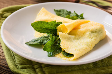 Homemade healthy spinach omelette on rural table