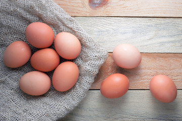 Some eggs on a sackcloth on a wooden table.