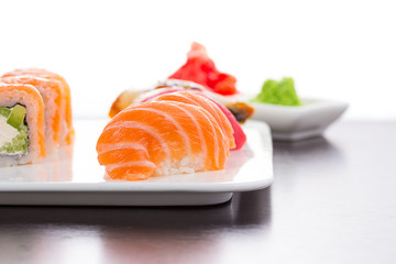 Japanese cuisine. Set of sushi nigiri on white plate.