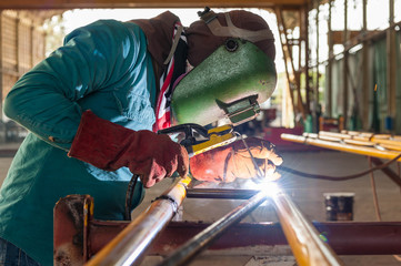 Worker welding the steel structure