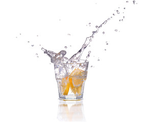 Orange or lemon slice fall in glass with water and make splash