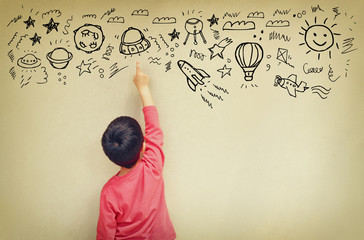 back view of cute kid imagine space travel with set of infograph