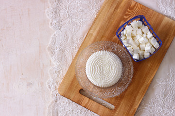 top view of greek cheese and bulgarian cheese on wooden table ov