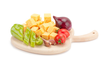 cheese and vegetables on wooden board