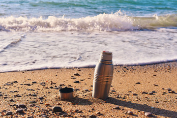 Heat protection-thermos coffee tea cup on the beach - 80872374