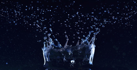 Fresh water splash like a crown on dark background