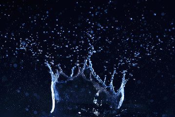 Fresh water splash like a crown on dark background