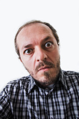 Fototapeta premium Surprised man in plaid shirt, eyes wide open