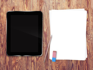 Tablette tactile et pages blanches sur fond de bois