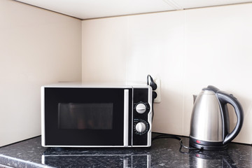 Close-up microwave and stainless electric kettle