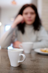Woman drinking coffee. Closeup white сup
