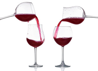 Red wine splash in the glass, pouring from a wineglass isolated