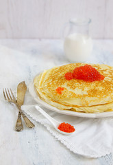 pancakes with red caviar on the white background