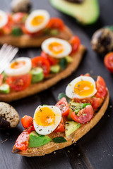 Bruschetta with tomato, avocado and quail egg