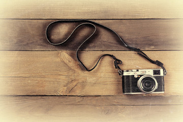 Retro camera on wooden planks background