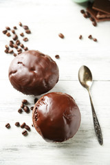 Tasty homemade chocolate muffins on wooden table