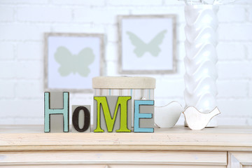 Home in colorful letters, in light white interior,