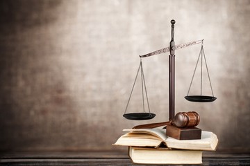 Law. Golden scales of justice, gavel and books isolated on white