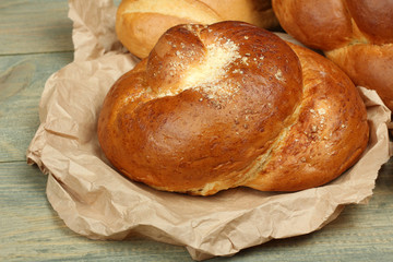 sweet bun on paper on a wooden background